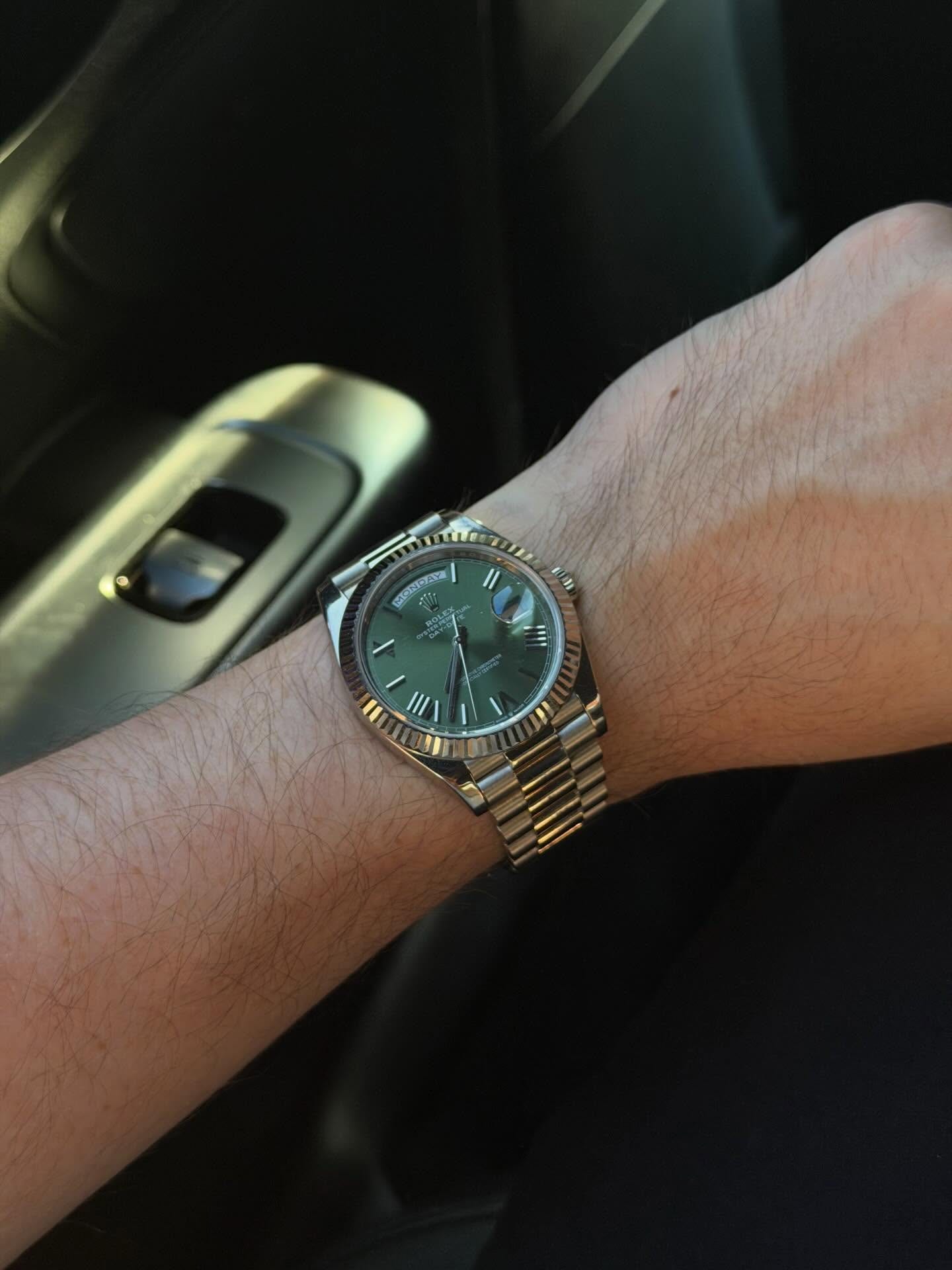 A Rolex Day-Date with a green dial