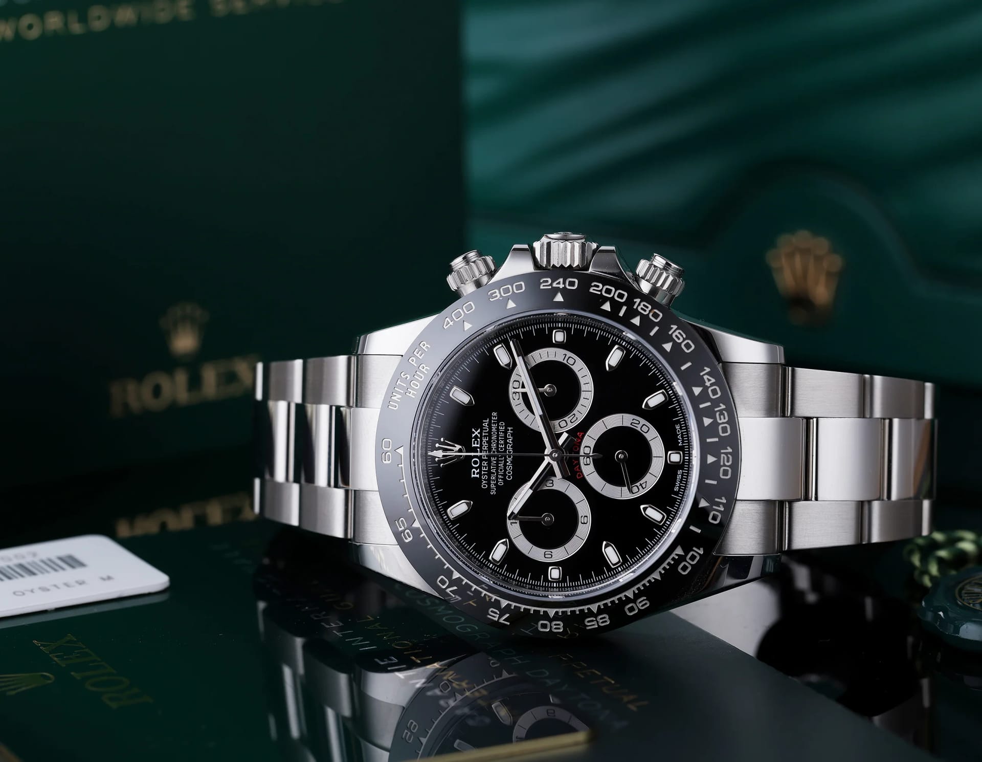 A Rolex Cosmograph Daytona in steel with a black dial, shown with its box