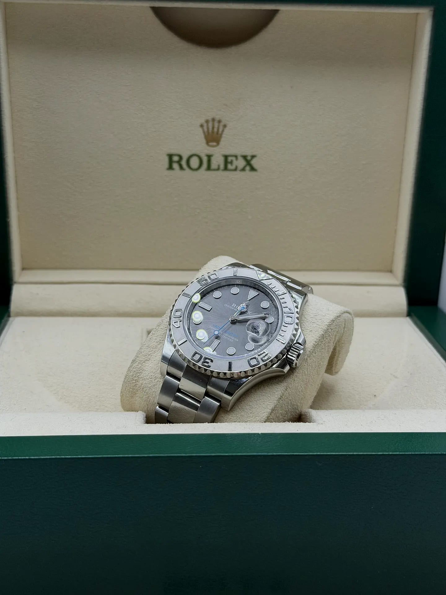 A Rolex Yacht-Master with a platinum bezel presented in its open green Rolex box